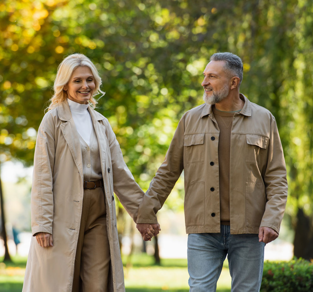 happy-mature-couple-strolling-through-park